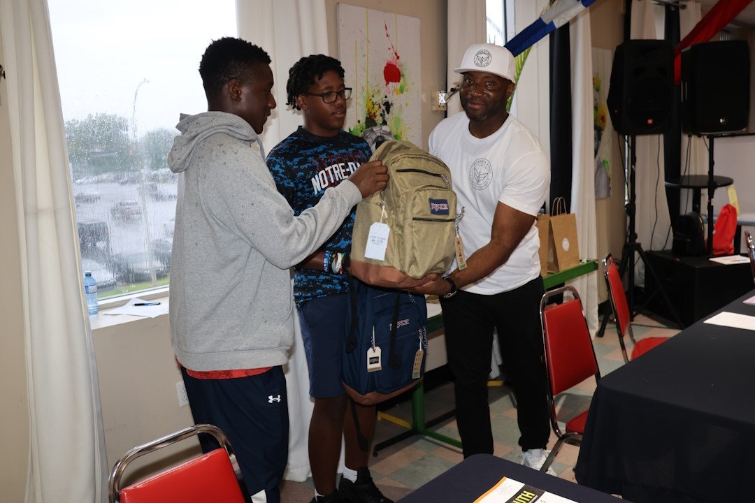 two-youths-and-a-man-holding-a-backpack.jpg